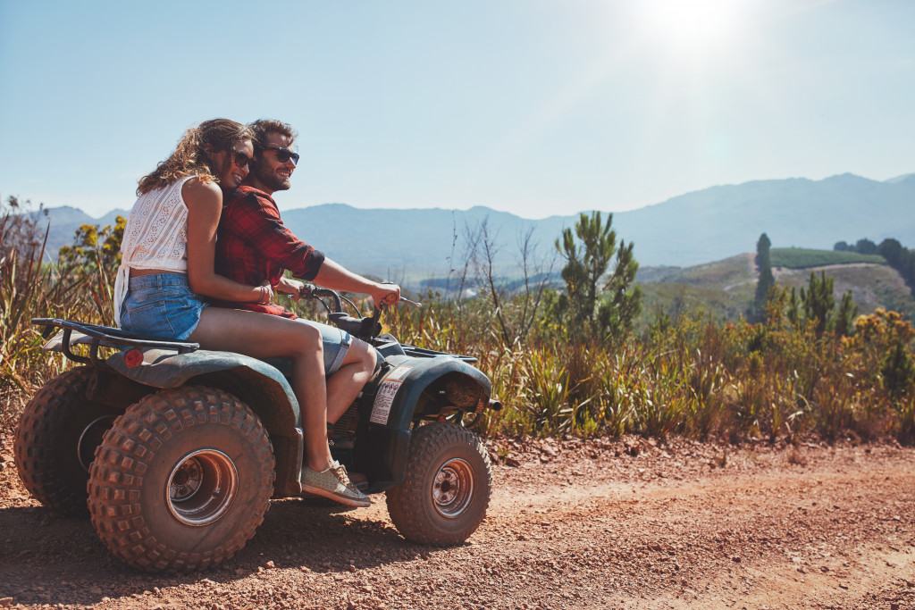 a couple on an ATV outdoors