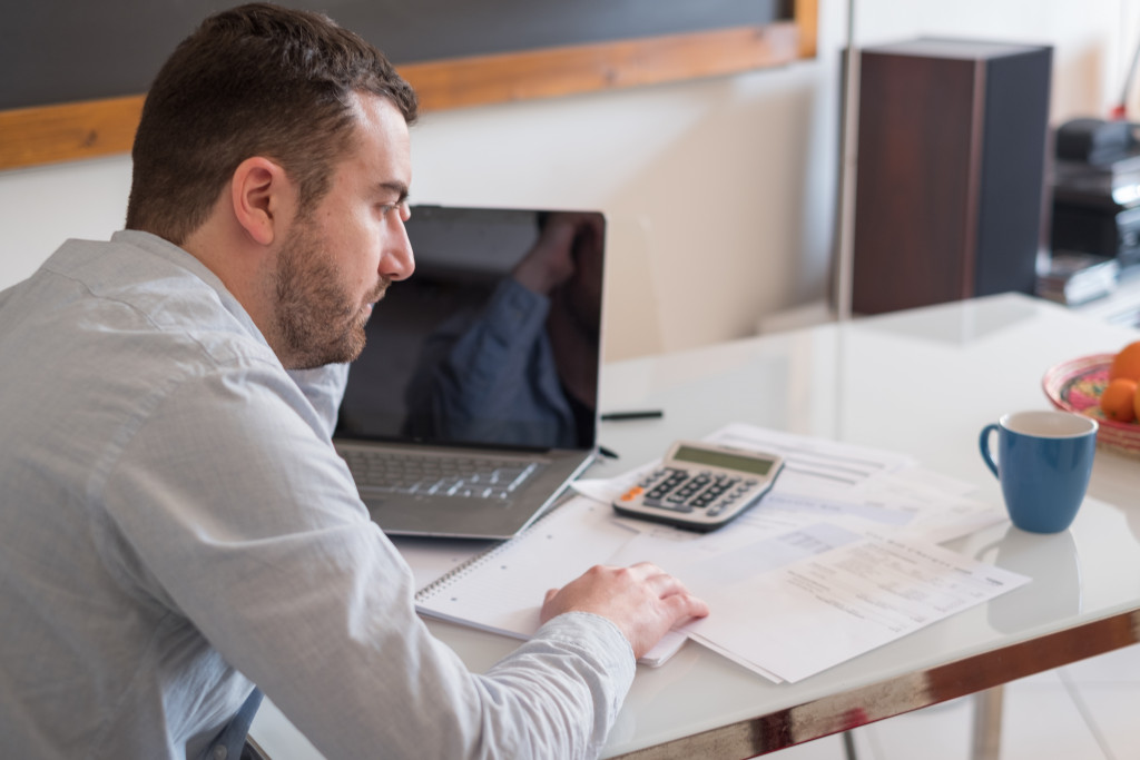 man with working on his finances