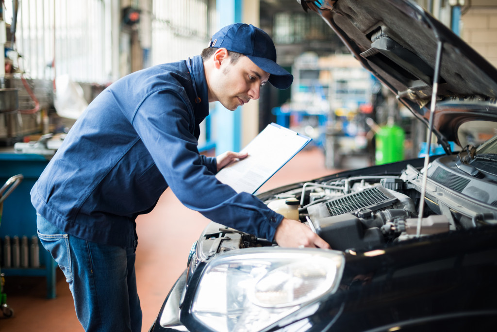 A mechanic checking a car