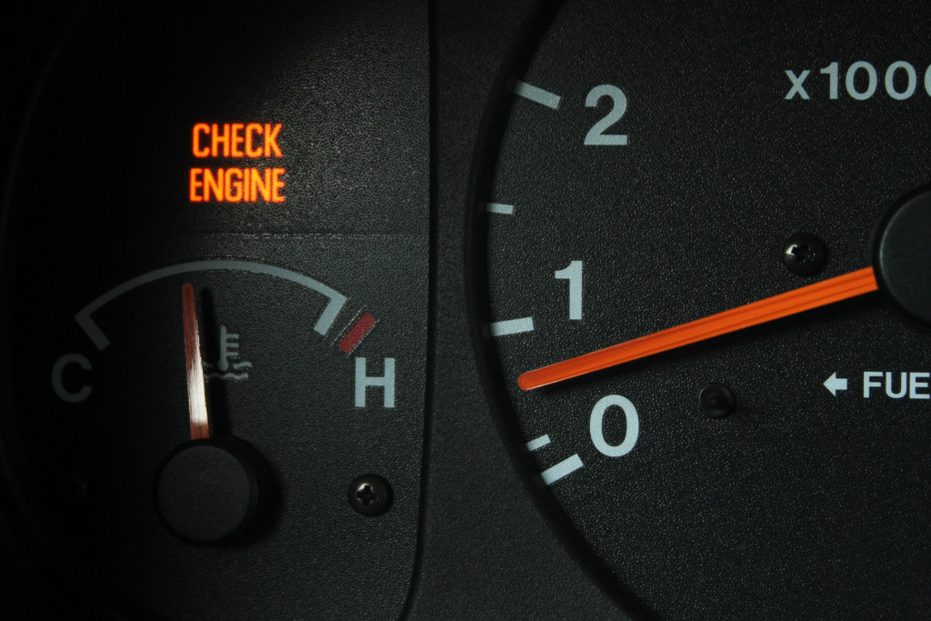 A lit up check engine sign on a dashboard