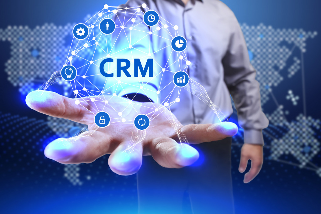 business man's hand holding CRM