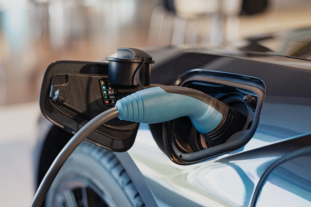 blue electric car being charged
