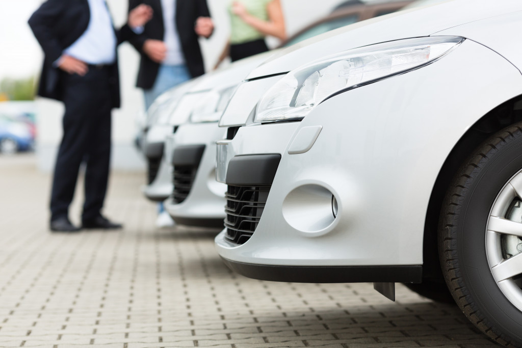a couple with a car dealer