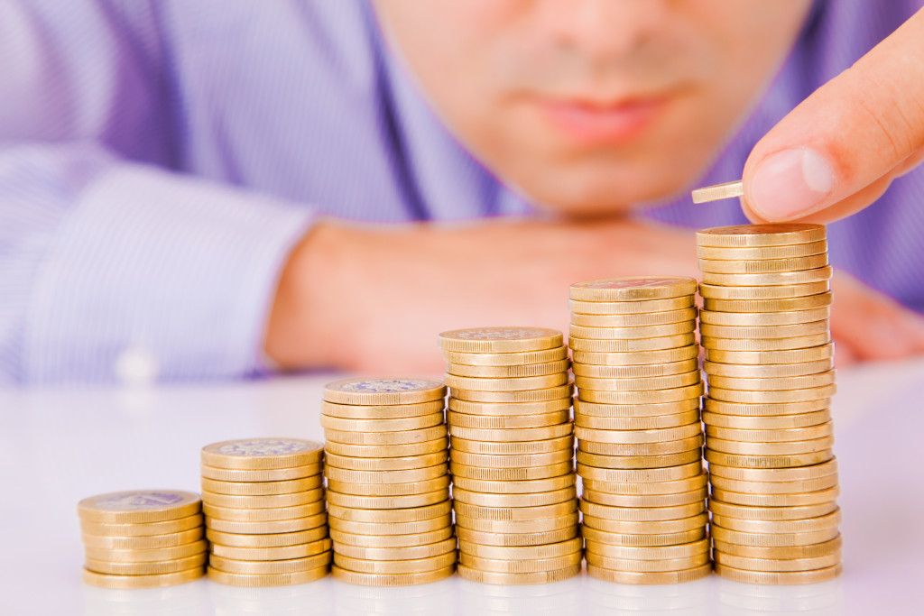 A businessman stacking coins