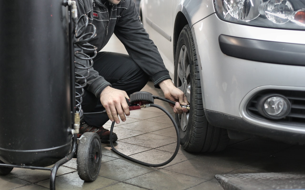 man pumping air into a tire