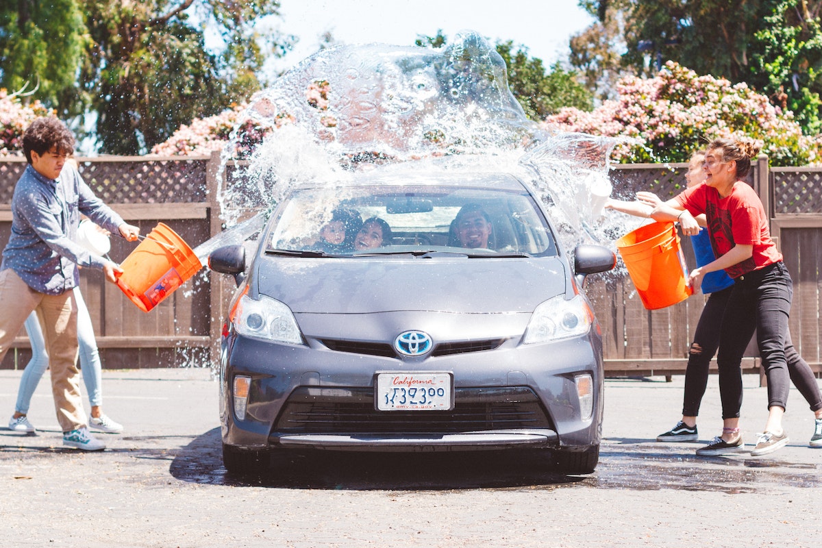 Four Children Washing Silver Toyota Prius