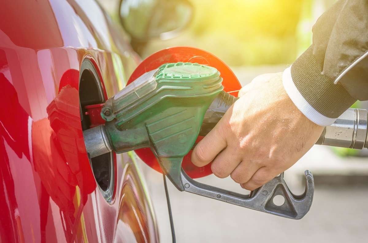 A man refilling his car with fuel